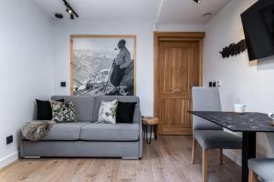 a living room with a couch and a table at Villa 7 Apartments in Zakopane