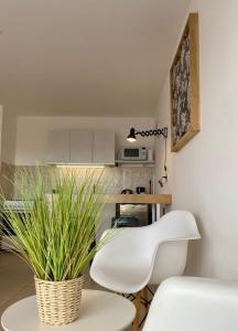 a living room with a white chair and a table at Penguins Flats 3 in Ushuaia