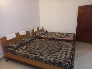 Postel nebo postele na pokoji v ubytování Mayura Rest Inn