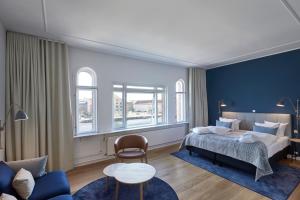 a bedroom with a bed and a blue wall at Copenhagen Strand in Copenhagen