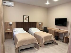 Кровать или кровати в номере Отель Александровский