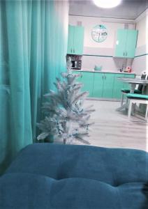 a christmas tree in a room with a kitchen at Апартаменти в центрі завжди зі світлом in Dnipro