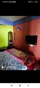 Katil atau katil-katil dalam bilik di Swarna Kamal Homestay