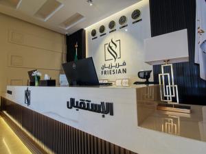 an office with a desk with a laptop on it at Friesian Hotel Apartments in Jeddah
