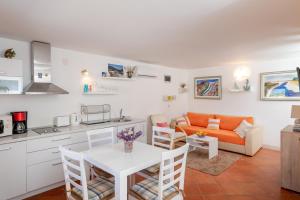 a kitchen and living room with a table and a couch at Holiday Home Anima Maris in Ston