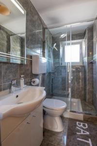a bathroom with a sink and a toilet and a shower at Holiday Home Anima Maris in Ston
