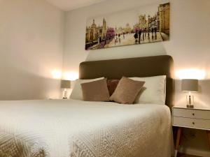 a bedroom with a large white bed with two lamps at Old Town Romantic Apartment. Breslau-Wroclaw. in Wrocław