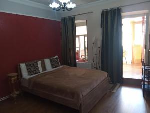 a bedroom with a bed and a chandelier at Apartment in the heart of Old Tbilisi in Tbilisi City