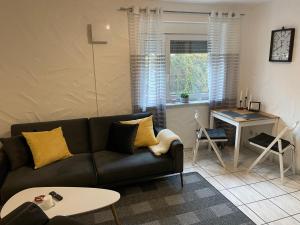 a living room with a couch and a table at Appartement in Bad Waldsee in Bad Waldsee