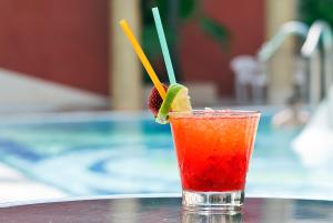 ein Getränk auf einem Tisch mit zwei Strohhalmen in der Unterkunft Cleopatra Spa Hotel in Lloret de Mar