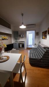 a kitchen and living room with a couch and a table at Relax Home in Bari