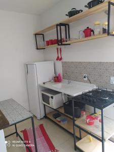 a kitchen with a counter and a sink and a refrigerator at Refúgio, paraquedismo, balão, 130 km de São Paulo in Pôrto Feliz