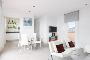 a white living room with a table and chairs at Stay U-nique Apartments Taulat in Barcelona
