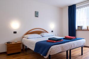 a bedroom with a bed with two towels on it at Casa Angelo in Molveno