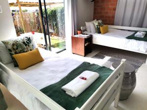 a bedroom with two beds with towels on it at Anna's Place in Jeffreys Bay