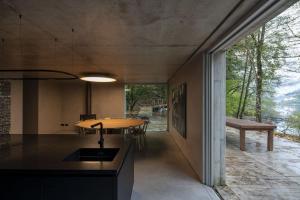 a kitchen with a table and a bench in a room at Casa do Ribeiro de Cândo in Vieira do Minho