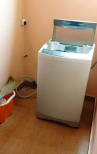 a small white refrigerator sitting in a room at 2 bedrooms house with jacuzzi terrace and wifi at Chamouny 4 km away from the beach in Mont Blanc