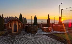 a backyard with a gazebo and a fire pit at Sanderson Apartments in Miercurea-Ciuc