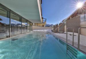 a swimming pool on the side of a building at Familienhotel Post in Serfaus