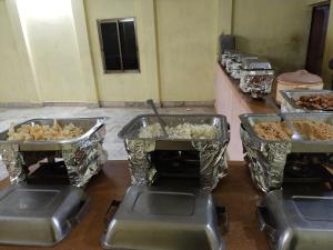 a bunch of trays of food in a kitchen at Aroma Desert Safari Camp in Sām