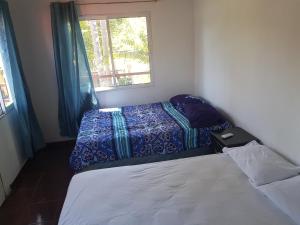 a small bedroom with two beds and a window at Rancho villas de alicia in La Paz +26 photos