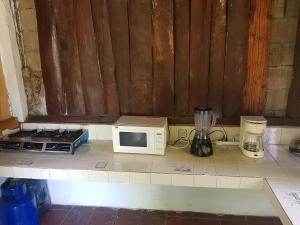 a kitchen counter with a microwave and a blender at Rancho villas de alicia in La Paz