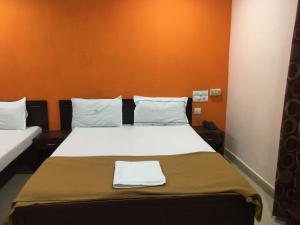 Cama o camas de una habitación en Delmon Residency