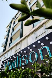 a building with a sign in front of it at Hotel Madison in Rimini