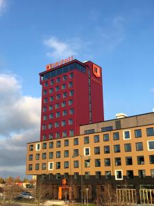 a hotel with a red building on top of it at Motel L Lund in Lund