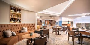 a restaurant with a couch and tables and chairs at Aminess Vival Maestral Hotel in Novigrad Istria