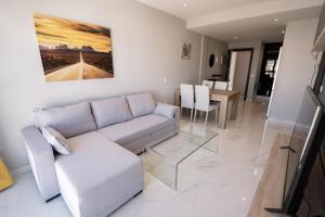 a living room with a couch and a table at Viviendas Vacacionales Aurea in Arrecife