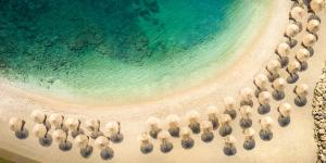 an aerial view of a beach with umbrellas at Aminess Vival Maestral Hotel in Novigrad Istria