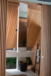 a bathroom with a sink and a wooden fence at Beyond Bayou in Seminyak