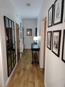a hallway with a desk and pictures on the wall at Award Winning Apartment in Yarm, North Yorkshire in Yarm