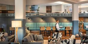 a lobby with a person standing at a bar at Aminess Vival Maestral Hotel in Novigrad Istria