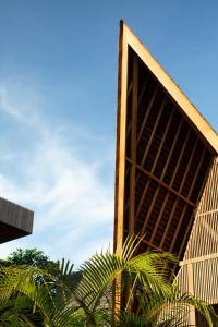 a building with a large window and some trees at Beyond Bayou in Seminyak