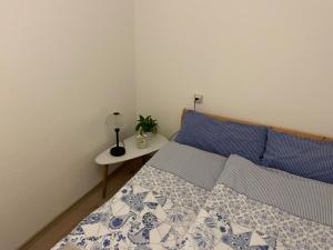 a bedroom with a bed and a table with a lamp at Appartement in Bad Waldsee in Bad Waldsee