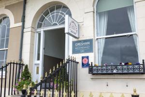 a black fence in front of a building at Gresham Guest House in Weymouth