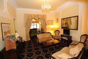 a living room filled with furniture and a chandelier at Bedford Hotel in Lytham St Annes