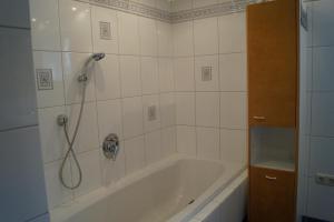 a bath tub in a bathroom with a shower at Ferienhaus Wille in Maurach