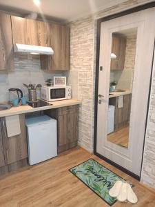 a kitchen with a counter and a microwave and a door at Апартаменты бизнесс-класса in Moscow