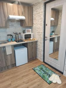 a kitchen with a counter and a door to a room at Апартаменты бизнесс-класса in Moscow