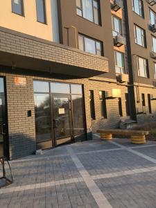 a building with a bench in front of it at Apartment near the airport in Boryspil