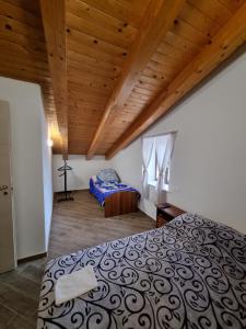 a bedroom with a bed and a wooden ceiling at Casa Vacanza Leo in Stilo