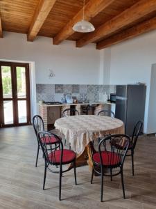 a kitchen with a table and chairs in a room at Casa Vacanza Leo in Stilo