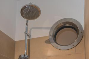 a metal toilet in a bathroom with a fan at SUITE & APART in Berlin +15 photos