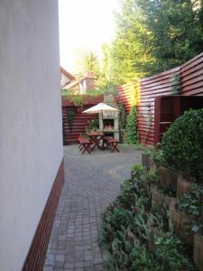 a patio with a table and an umbrella at Mirex in Krynica Zdrój