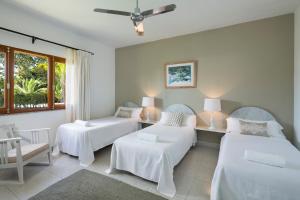 a room with three beds and a window at Hotel Punta Sur in Tarifa