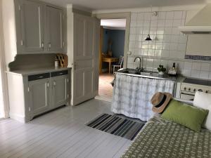a kitchen with a couch and a kitchen with a sink at Havings skafferi in Lysekil +24 photos