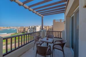 a balcony with a table and chairs and a view at Golden Apartments El Gouna in Hurghada